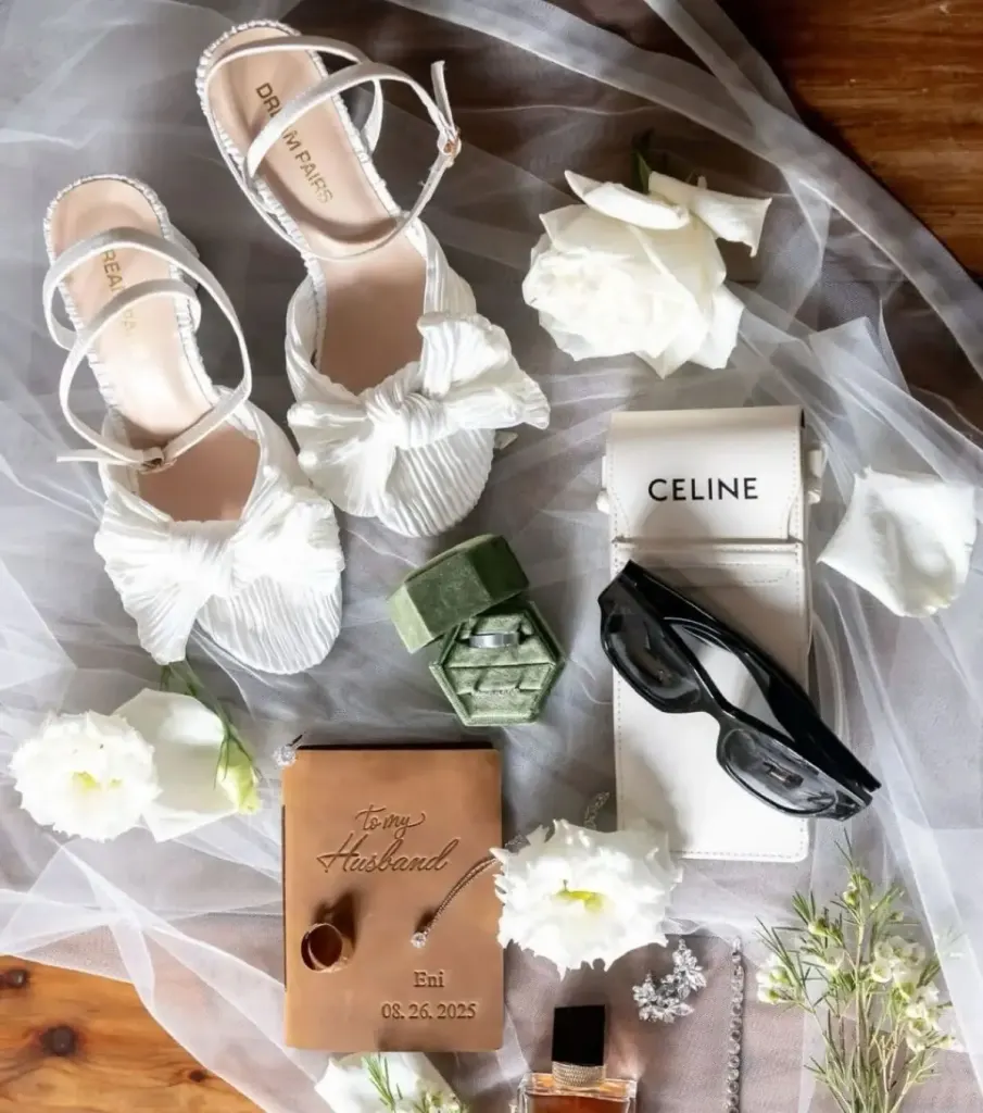 Translations & interpreting Bridal details: white shoes, rings, vow book and flowers on a veil